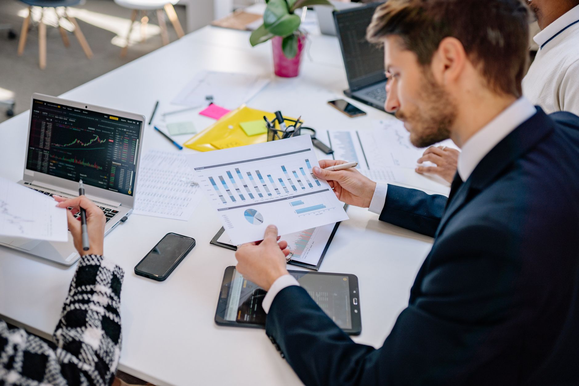 a businessman looking at graphs printout